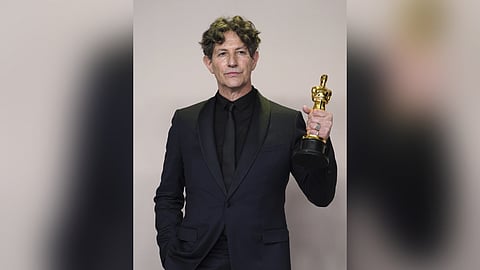 Jonathan Glazer poses with the award for "The Zone of Interest" from the United Kingdom, for best international feature film in the press room at the Oscars on Sunday, March 10, 2024