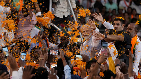 Prime Minister Narendra Modi greets supporters as he arrives for an election campaign rally of the Bharatiya Janata Party (BJP) in Hyderabad.