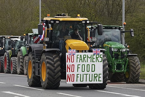 A convoy of farmers in tractors gather on the A20, near Wrotham, in Kent, England before heading to London to join a protest in Westminster, Monday, March 25, 2024.