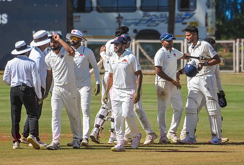 Mumbai and Tamil Nadu players walk off the field after the semi final.