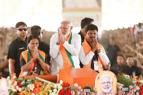 PM Modi coming with Davanagere candidate Gayathri Siddeshwar and Shivamogga candidate B Y Raghavendra to the venue of the election rally held in Shivamogga on Monday (Photo | Express)