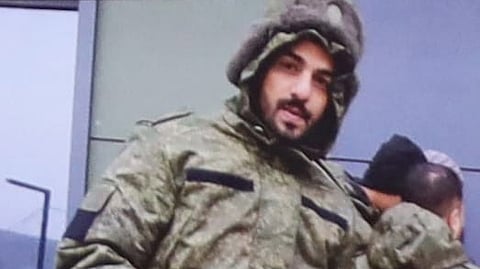 A picture of Mohammed in a military outfit.