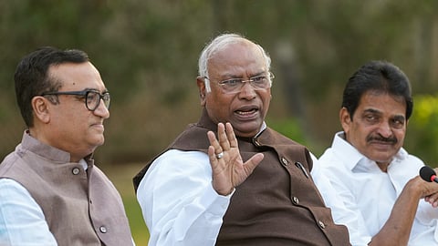 Congress President Mallikarjun Kharge with party leaders Ajay Maken and K.C. Venugopal addresses a press conference at his residence, in New Delhi.