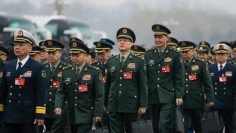 Delegates arrive to attend the opening session of the The National People's Congress (NPC) at the Great Hall of the People in Beijing
