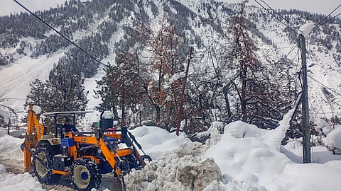 A snow clearing machine being used to remove snow from a road at Sissu, in Lahaul and Spiti district.