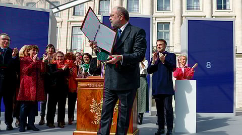 France's Justice Minister Eric Dupond-Moretti and President Emmanuel Macron, background right, attend a ceremony to seal the right to abortion in the French constitution, on International Women's Day, at the Place Vendome, in Paris, France March 8, 2024.