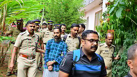 Police officers coming out with the accused Nitheesh from the Kakkattukada house, where Vijayan was murdered and buried.