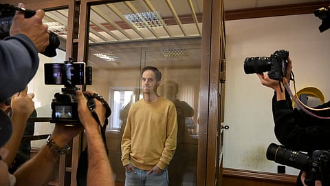 Wall Street Journal reporter Evan Gershkovich stands in a defendants’ cage at a hearing in Moscow, Russia, on Tuesday, Sept. 19, 2023.