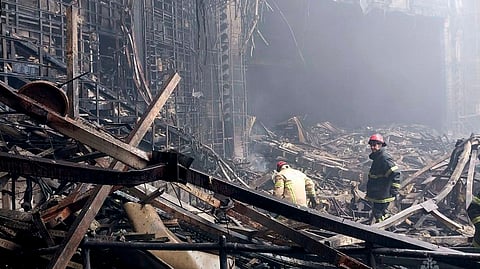 In this photo released by the Russian Emergency Ministry Press Service on March 23, 2024, firefighters work in the burned concert hall after an attack on the building of the Crocus City Hall on the western edge of Moscow, Russia.