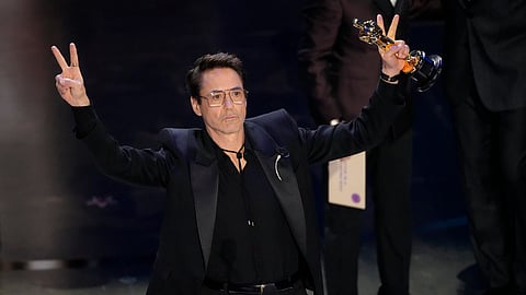 Robert Downey Jr. accepts the award for best performance by an actor in a supporting role for "Oppenheimer" during the Oscars on Sunday, March 10, 2024, at the Dolby Theatre in Los Angeles.