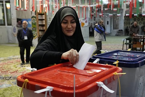 A woman casts her ballot during the parliamentary and Assembly of experts elections at a polling station in Tehran, Iran, Friday, March 1, 2024.