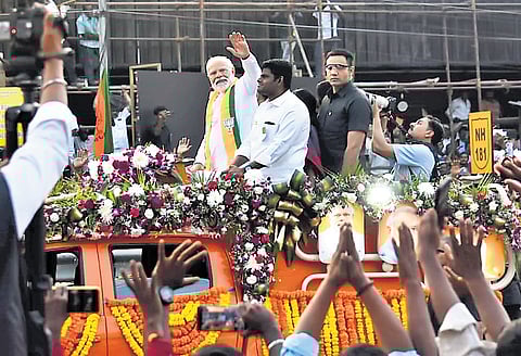 PM Narendra Modi waving to the people in Coimbatore.