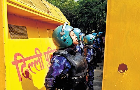 RAF women personnel stand guard in central Delhi given protest by AAP against ED, BJP.