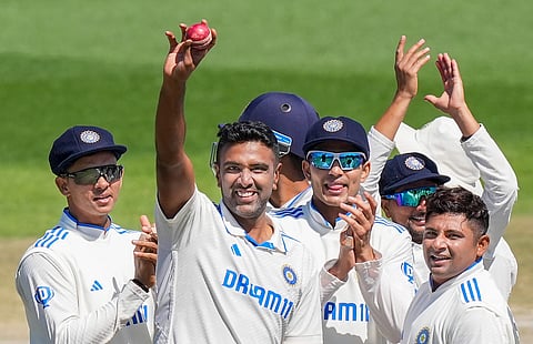 India's R Ashwin shows the ball as he takes a five-wicket haul during the 3rd day of the fifth Test cricket match between India and England, in Dharamsala, Satutday, March 9, 2024.