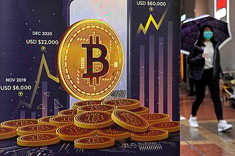 An advertisement for Bitcoin cryptocurrency is displayed on a street in Hong Kong,