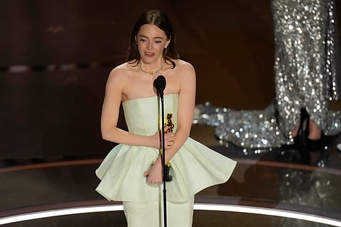 Emma Stone accepts the award for best performance by an actress in a leading role for "Poor Things" during the Oscars on Sunday, March 10, 2024, at the Dolby Theatre in Los Angeles.