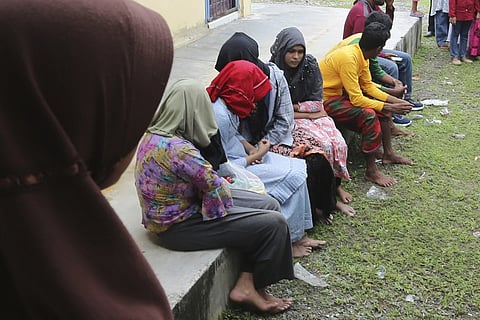 Ethnic Rohingya people rescued from their capsized boat rest at a local government building in Samatiga, Aceh province, Indonesia, Wednesday, March 20, 2024.