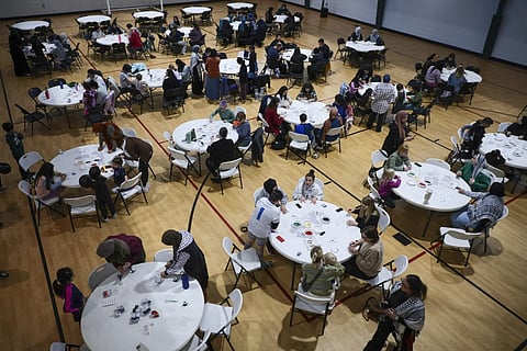 People gather to make bracelets with former Girl Scout Troop 149 as they fundraise for children affected by the war in Gaza at the Dar Al Jalal Masjid Mosque in Hazelwood, Mo. on March 2, 2024.