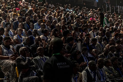 People seat at the Kigali Arena stadium in Kigali on April 7, 2024 before the commemoration of Kwibuka 30, the 30th commemoration of the 1994 genocide against the Tutsi.