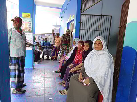 Voters waiting at polling booth number 56 in Attingal LS Constituency of Kerala after the voting machine malfunctioned.