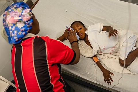 Denize Flerino wipes sweat from the brow of her son who is suffering from high fevers at a Doctors Without Borders emergency room in the Cite Soleil neighborhood of Port-au-Prince, Haiti, Friday, April 19, 2024.