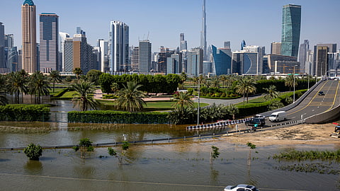 An abandoned vehicle stands in floodwater caused by heavy rain with the Burj Khalifa, the world's tallest building, seen on the background, in Dubai, United Arab Emirates.