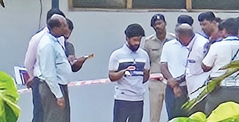 Accused Fayaz (centre) arrives at the crime scene on the BVB College campus, accompanied by CID officers, in Hubballi on Wednesday