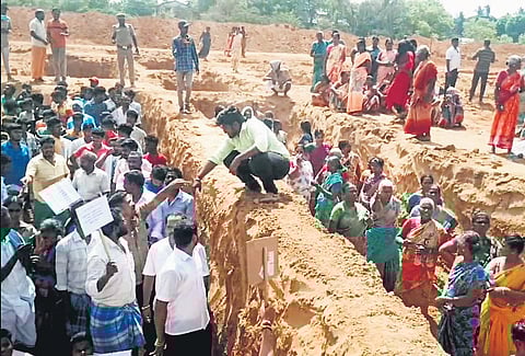 Villagers protested at the construction site of the Vallalar International Centre at Vadalur by standing in the foundation dug for the building