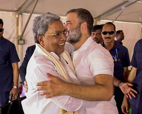 Congress leader Rahul Gandhi greets Karnataka Chief Minister Siddaramaiah during an election rally