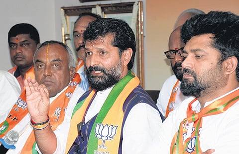Senior BJP leader CT Ravi addresses a press meet, as sitting BJP Mysuru-Kodagu MP Pratap Simha looks on, in Mysuru on Monday