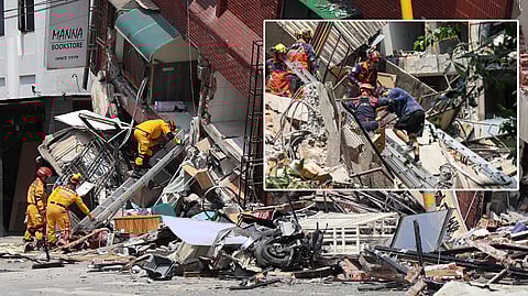 Emergency workers assisting a survivor after he was rescued from a damaged building in New Taipei City, after a major earthquake hit Taiwan's east.