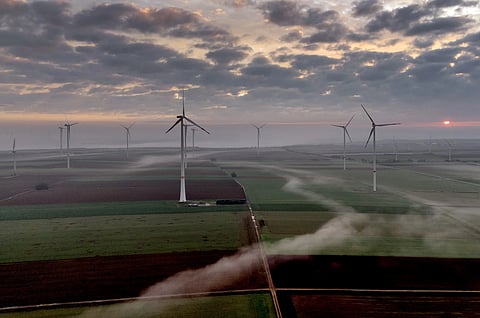 Wind turbines operate at an energy plant near Stetten, north of Kaiserslautern, Germany, as the sun rises on March 19, 2024.
