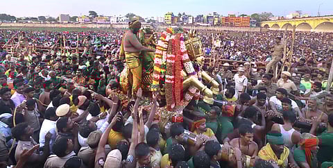Lord Kallazhagar is seen entering Vaigai River as a part of Chithirai Festival at Madurai on Tuesday
