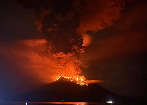 This handout photograph taken and released by the Center for Volcanology and Geological Hazard Mitigation on April 17, 2024, shows Mount Ruang releasing hot lava and smoke in Sangihe Islands as seen from Sitaro, North Sulawesi.