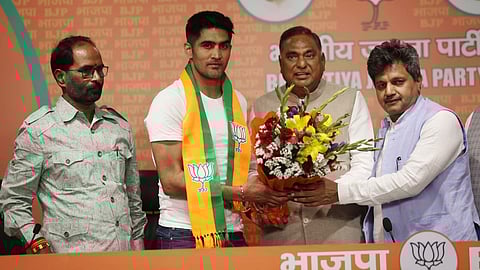 Boxer and former Congress leader Vijender Singh joins BJP in the presence of the party's National General Secretary Vinod Tawde in Delhi on Wednesday.