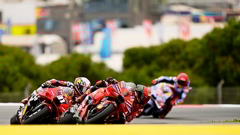 MotoGP rider Francesco Bagnaia of Italy, center, takes a curve followed by Pedro Acosta of Spain, left, and Marc Marquez, also of Spain, right, during the Portuguese Motorcycle Grand Prix at the Algarve International circuit near Portimao, Portugal, Sunday, March 24, 2024.