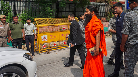 Yoga guru Ramdev arrives at the Supreme Court for a hearing on the Patanjali misleading advertisements case, in New Delhi.