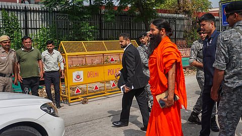 Yoga guru Ramdev arrives at the Supreme Court for a hearing on the Patanjali misleading advertisements case, in New Delhi.