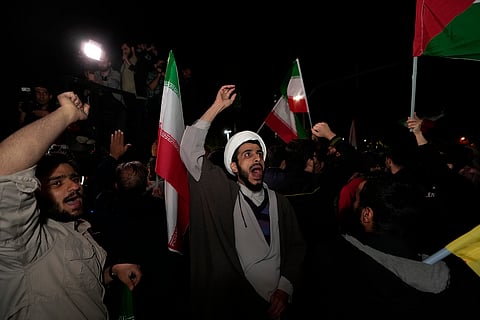 Iranian demonstrators chant slogans during their anti-Israeli gathering in front of the British Embassy in Tehran, Iran, early Sunday, April 14, 2024.