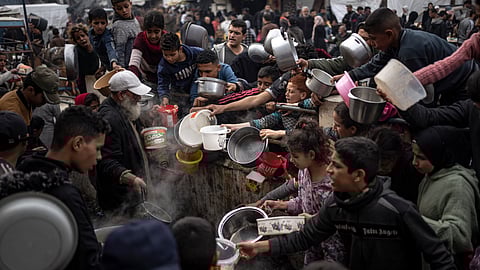 Palestinians line up for a meal in Rafah, Gaza Strip, on Thursday, Dec. 21, 2023.