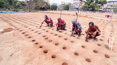 Labourers digging the pits for the sample fireworks display of Thrissur Pooram for Paramekkavu faction at Thekkinkadu Maidan.