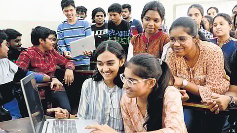 Second PU students are all smiles after checking their results online at a college in the city on Wednesday