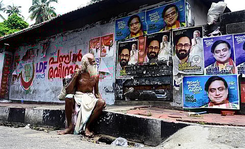 An old man looking at posters of candidates in the Thiruvananthapuram Lok Sabha constituency.