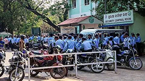 Security personnel protest outside Capital Hospital over non-payment of salary, in Bhubaneswar on Saturday.