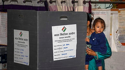 A voter casts her vote for the first phase of Lok Sabha elections, in Sivasagar, Assam, Friday, April 19, 2024.