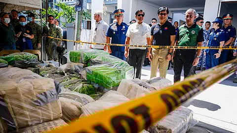 Philippine President Ferdinand Marcos (C, in white shirt) and Interior Secretary Benhur Abalos (2nd R) inspect seized methamphetamine drugs in Alitatag town in Batangas province on April 16, 2024.