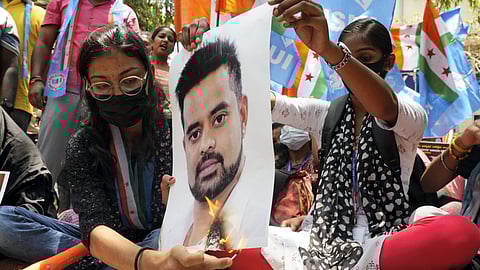 Protestors burn a poster of JD(S) MP Prajwal Revanna during a protest against his involvement in the alleged sexual abuse case.