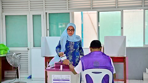 A woman casts her vote at a polling station in Male, India, Sunday, April 21, 2024.