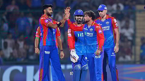 Delhi Capitals' Kuldeep Yadav, second right, celebrates the wicket of Gujarat Titans' Rahul Tewatia during IPL match between Delhi Capitals and Gujarat Titans in New Delhi.