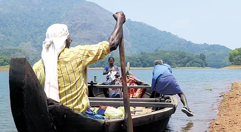 Thankappan rowing a traditional boat from Amboori to Puravimala tribal settlement.